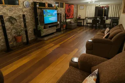 a living room with two couches and a flat screen tv at Casa Victoria