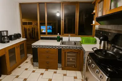 a kitchen with a sink and a stove at Casa Victoria
