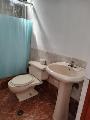 a bathroom with a toilet and a sink at Family Days in Ica
