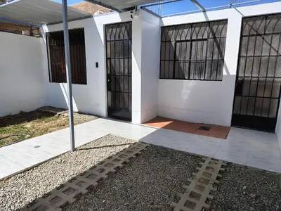 a white building with black barred windows on it at Family Days in Ica