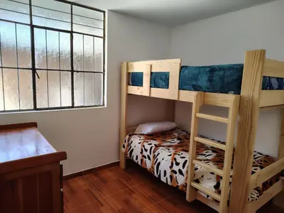 a bedroom with two bunk beds and a desk at Family Days in Ica
