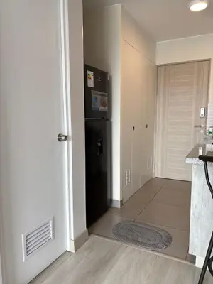 a kitchen with a black refrigerator next to a door at Acogedor Loft con ubicación céntrica en Lima in San Antonio