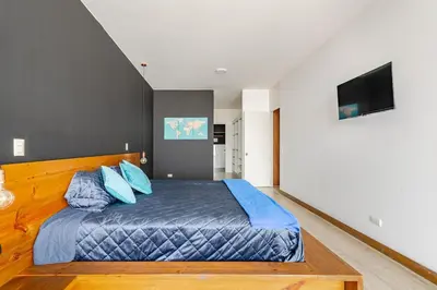 a bedroom with a large bed with blue pillows at Miraflores - departamento con 3 dormitorios in Lima