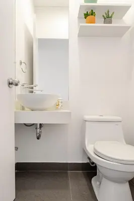 a bathroom with a white toilet and a sink at Miraflores - departamento con 3 dormitorios in Lima