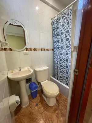 a bathroom with a toilet and a sink and a mirror at Misky Illari Hospedaje in Ica