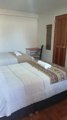 two beds sitting next to each other in a room at Refugio Sagrado Boutique in Cusco