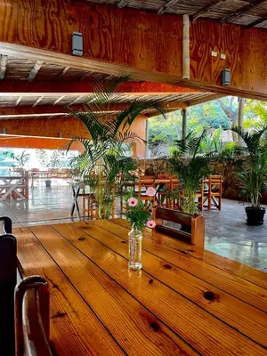a large wooden table in a room with plants at Rosa Estela in Cieneguilla