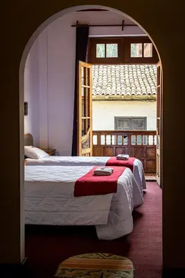 a bedroom with a bed with a red blanket at Casona Santa Catalina Cusco in Cusco