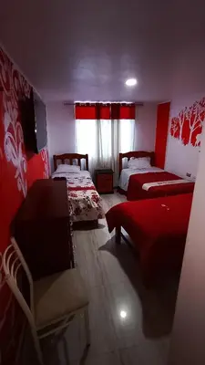 a room with two beds and a couch in it at Hotel D'Gloria Churin in Churín