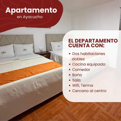a bed in a room with avertisement for at Departamentos Sumaq Plaza - Bellido in Ayacucho
