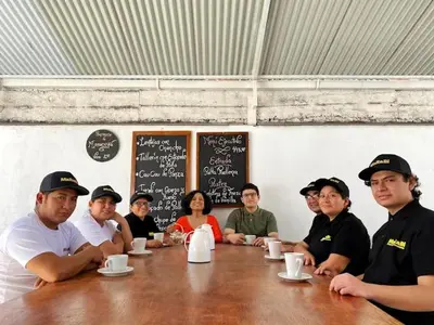 a group of people sitting around a table at Hotel Marabi in Quillabamba
