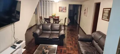 a living room with a leather couch and a table at Duplex en San Borja in Lima
