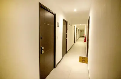 a hallway with black doors and a tile floor at View & Pool Barranco loft G15 in Lima