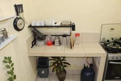 a small kitchen with a counter top with a stove at Apartamento Privado en San Pedro Cusco in Cusco