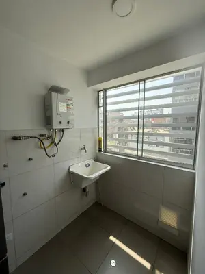 a bathroom with a sink and a window at Departamento San Sebastian in Lima