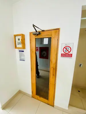 a bathroom with a wooden door in a room at San Miguel Apartment Vista Mar in Lima
