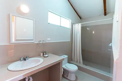 a bathroom with a sink and a toilet and a shower at Hotel Villarma in Alis
