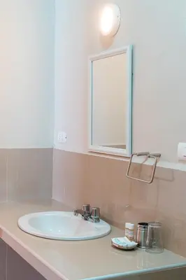 a bathroom with a white sink and a mirror at Hotel Villarma in Alis