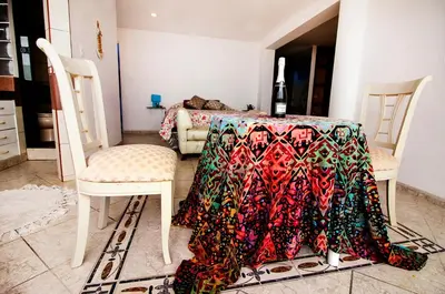 a table with a table cloth on it with two chairs at Casa Las Brisas de Villa frente al mar in Lima