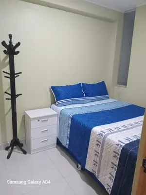 a bedroom with a bed with a cross on it at Hospedaje TITANIC in Huancayo