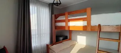 a bedroom with two bunk beds and a window at Casa con piscina, terraza y parrilla en Ica in Ica