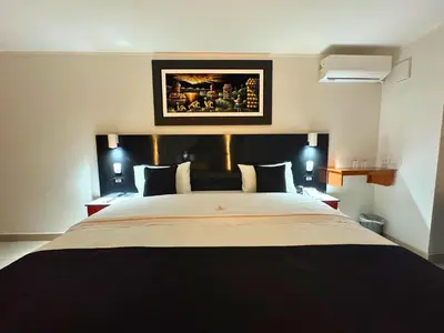 a bedroom with a large bed with two night stands at City Tower Hotel in Lima
