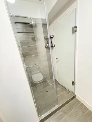 a glass shower in a bathroom with a toilet at San Isidro Financial Flat Lima in Lima