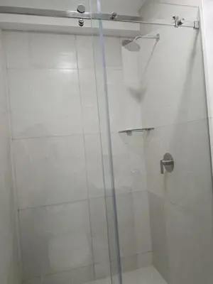a shower with a glass door in a bathroom at HK5 Bed And Breakfast Apartment in Lima