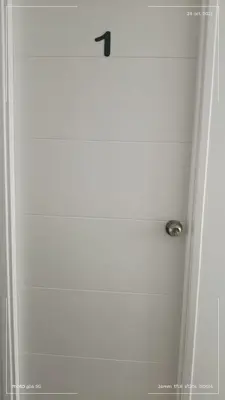 a bathroom door with a black arrow on it at HK5 Bed And Breakfast Apartment in Lima