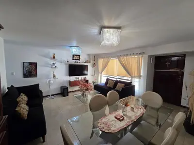 a living room with a glass table and chairs at Completo, Moderno y Confortable Departamento in Lima