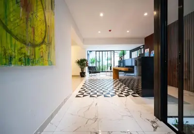 a living room with a tile floor and a painting at Beautiful and quiet aparment, near to Larcomar, cliff, Kennedy Park in Lima