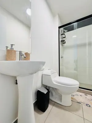 a white bathroom with a sink and a toilet at A unos pasos de la Arena in Puerto Viejo