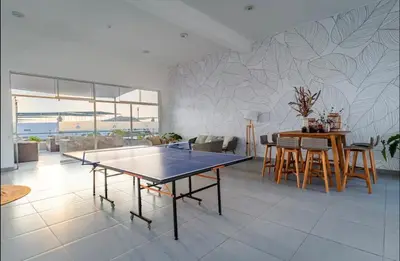 a living room with a ping pong table in it at A unos pasos de la Arena in Puerto Viejo