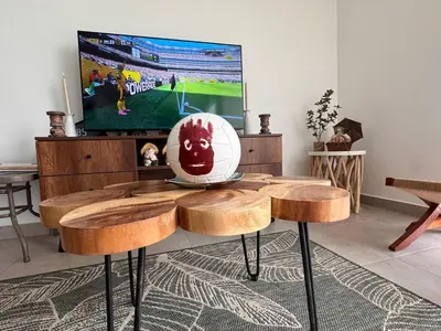 a living room with a table with a football on it at A unos pasos de la Arena in Puerto Viejo