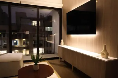 a living room with a couch and a large window at Estancia de lujo en Miraflores Entre Marriott y Pullman in Lima