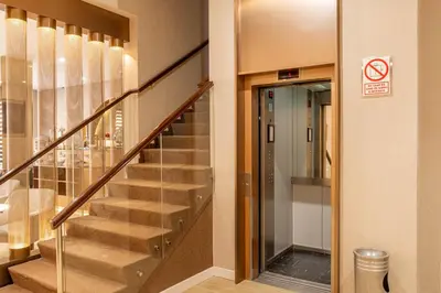 a hallway with stairs in a building with a no entry sign at El Marquez Huancayo in Huancayo