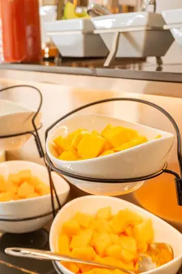 three bowls of fruit on a counter in a kitchen at El Marquez Huancayo in Huancayo