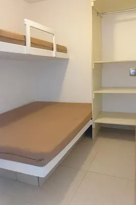 a small room with a bed and shelves at Departamento con Jacuzzi privado y acceso directo al mar in Asia