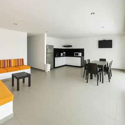 a kitchen and dining room with a table and chairs at Departamento con Jacuzzi privado y acceso directo al mar in Asia