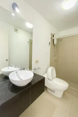 a bathroom with a sink and a toilet and a mirror at Departamento con Jacuzzi privado y acceso directo al mar in Asia