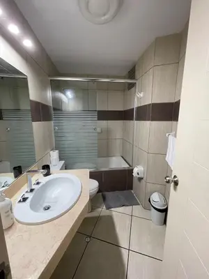 a bathroom with a sink and a toilet and a tub at Cozy and Centric Flat with Great View and Parking in Lima