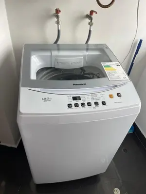 a washing machine is sitting in a room at Cozy and Centric Flat with Great View and Parking in Lima