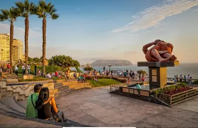 a statue of a woman sitting next to the ocean at Cozy and Centric Flat with Great View and Parking in Lima