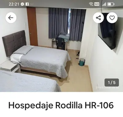 a hotel room with two beds and a television at Hotel Rodilla in Ayacucho