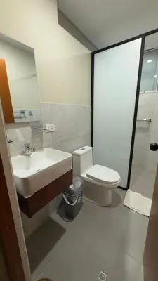 a bathroom with a sink and a toilet and a mirror at Hotel Rodilla in Ayacucho