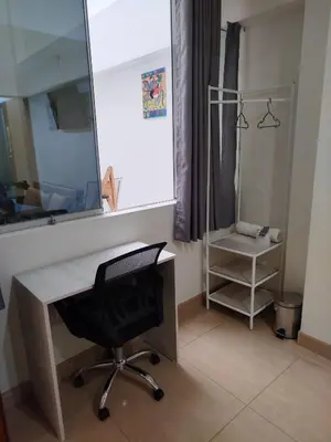 a desk with a chair and a mirror in a room at Hotel Rodilla in Ayacucho