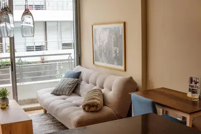 a living room with a couch and a table at Departamento Athelier in Lima