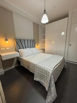 a bedroom with a bed with a chair in it at Hospedaje Bry Ker in Pichanaki