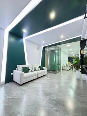 a living room with a white couch and a blue wall at Hospedaje Bry Ker in Pichanaki