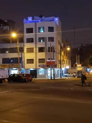 a building with a blue light on top of it at night at Hotel World Peru in Lima